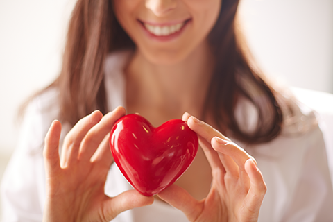 close-up-woman-holding-bright-heart